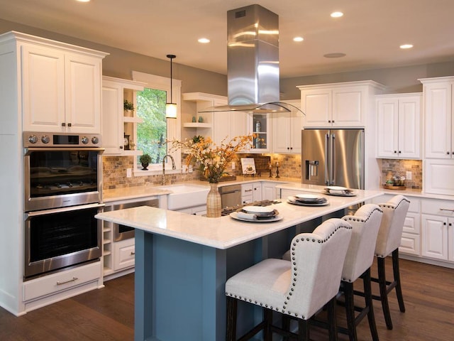 kitchen featuring island range hood, a kitchen island, dark wood-type flooring, white cabinets, and appliances with stainless steel finishes