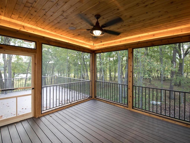 unfurnished sunroom with wooden ceiling and ceiling fan