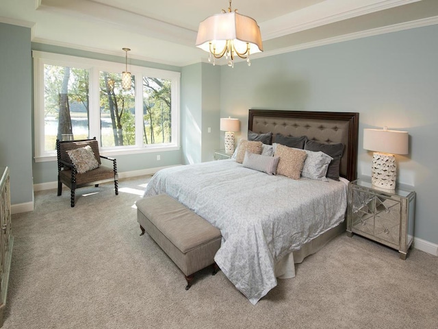 carpeted bedroom with ornamental molding and a notable chandelier