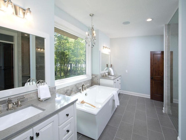 bathroom featuring vanity, tile patterned flooring, plenty of natural light, and a washtub