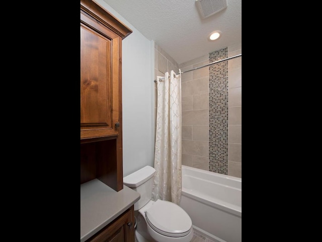 full bathroom with vanity, toilet, a textured ceiling, and shower / bath combo