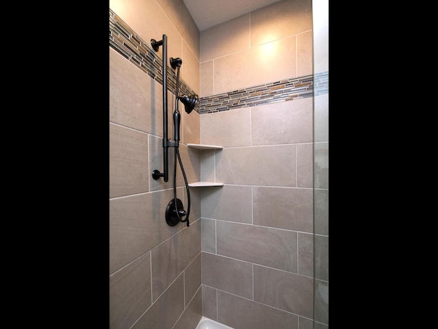 bathroom with a tile shower