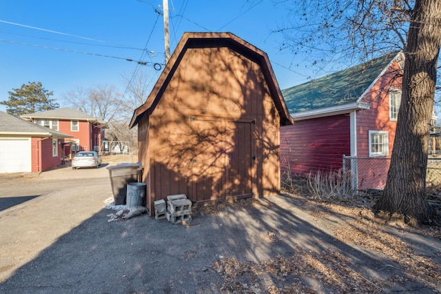 rear view of house featuring a storage shed