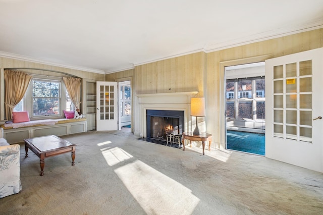 carpeted living room featuring ornamental molding