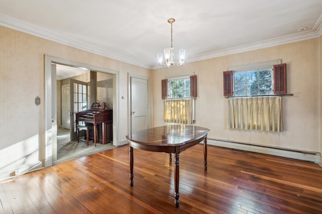 dining space featuring dark hardwood / wood-style floors, ornamental molding, baseboard heating, and a chandelier