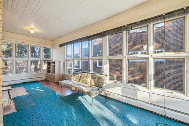 unfurnished sunroom featuring plenty of natural light, baseboard heating, and wooden ceiling