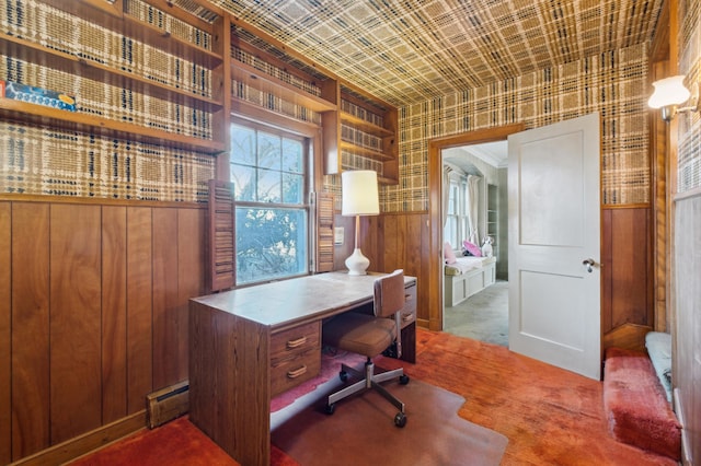 carpeted office featuring wood walls