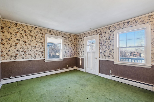 carpeted empty room featuring crown molding and a baseboard radiator