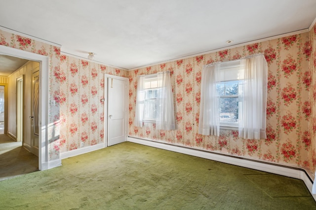 spare room with carpet flooring and a baseboard heating unit