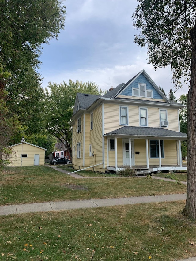 farmhouse with a porch, cooling unit, and a front lawn