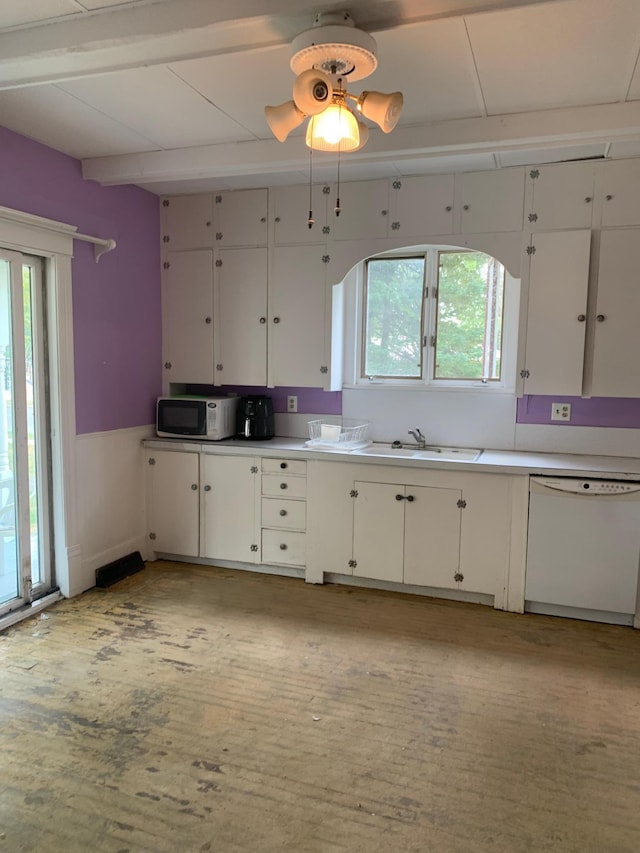 kitchen with a healthy amount of sunlight, sink, white cabinetry, and white appliances