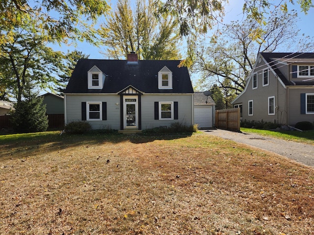 cape cod house with a garage and a front yard