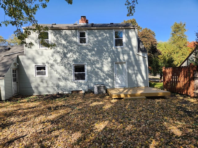 back of house with a wooden deck and cooling unit