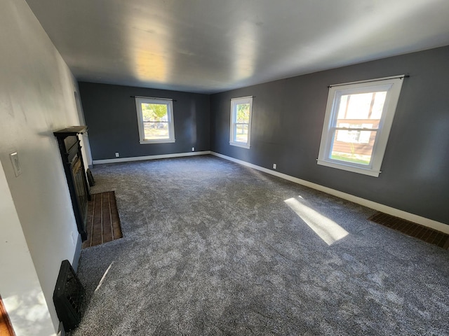 unfurnished living room with dark colored carpet