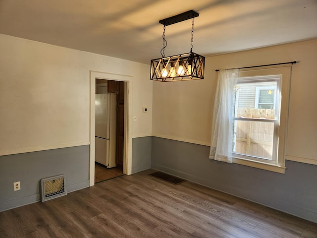 spare room featuring wood-type flooring