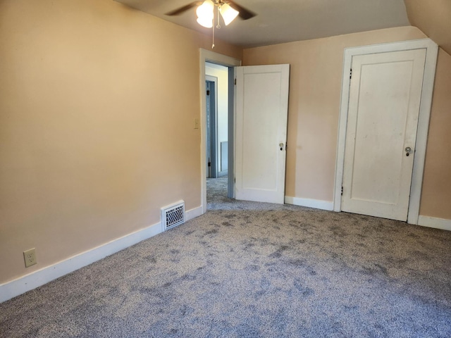 unfurnished bedroom featuring carpet flooring, ceiling fan, and vaulted ceiling