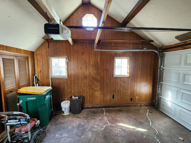 garage with wooden walls and a garage door opener