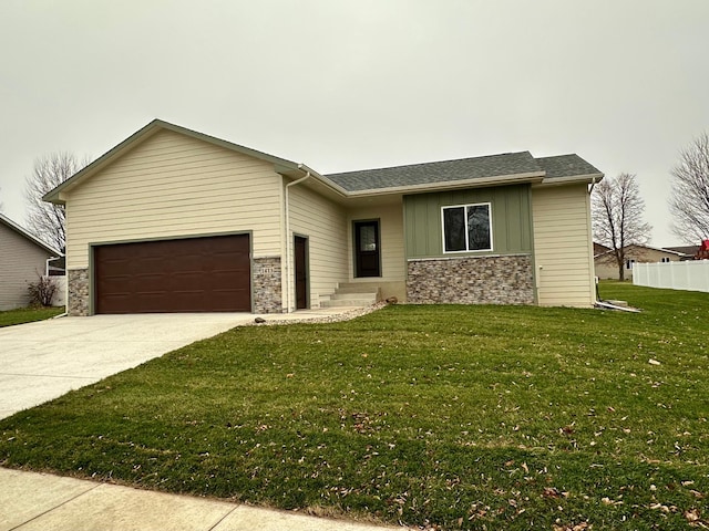 ranch-style home featuring a front yard and a garage