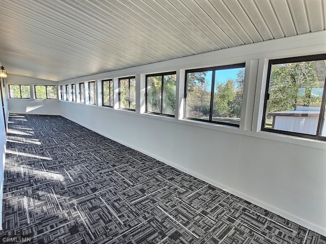 unfurnished sunroom featuring vaulted ceiling