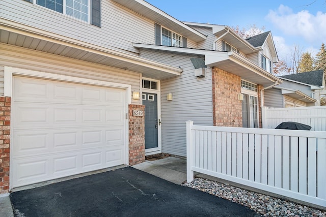 view of exterior entry with a garage