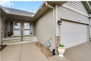 view of side of home featuring covered porch and a garage