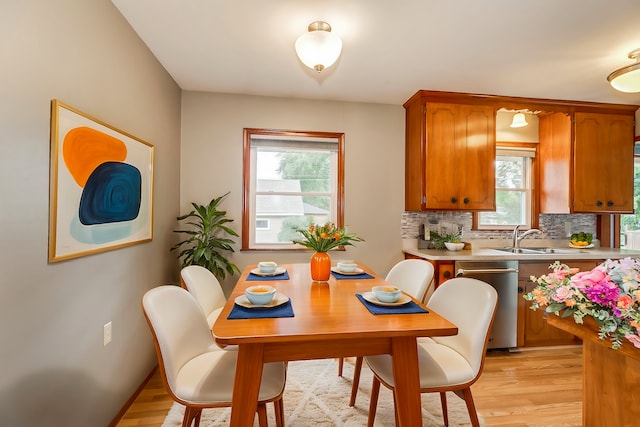 dining room featuring light wood-type flooring and sink