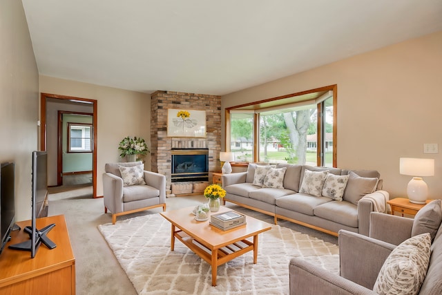 carpeted living room featuring a fireplace