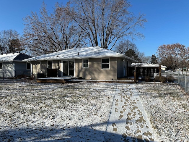 view of snow covered rear of property