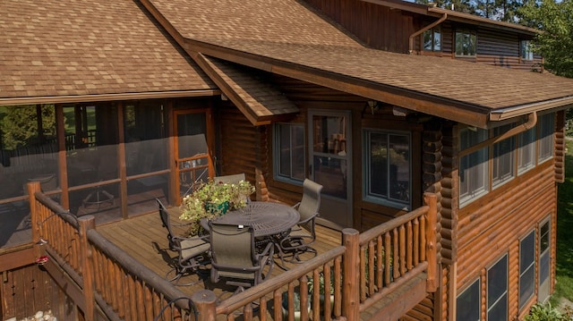 wooden deck with a sunroom