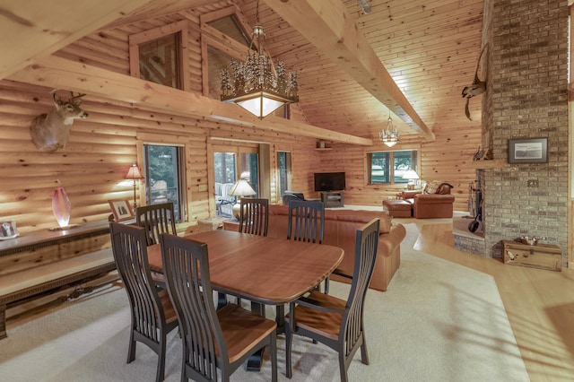 dining area with a brick fireplace, light hardwood / wood-style floors, wooden ceiling, beam ceiling, and high vaulted ceiling