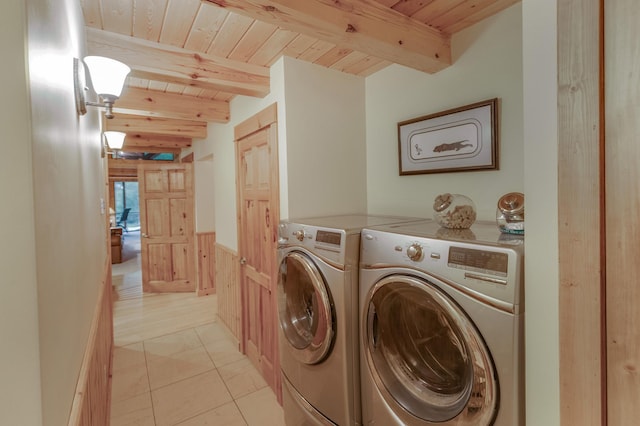 washroom featuring wood ceiling, wooden walls, separate washer and dryer, and light tile patterned floors