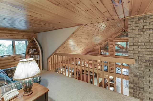 interior space featuring wooden walls, vaulted ceiling, carpet floors, and wooden ceiling