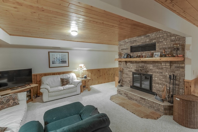 carpeted living room featuring wood ceiling, a brick fireplace, and wooden walls