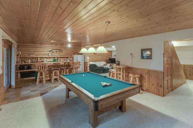 game room with pool table, bar area, carpet floors, wooden ceiling, and wooden walls