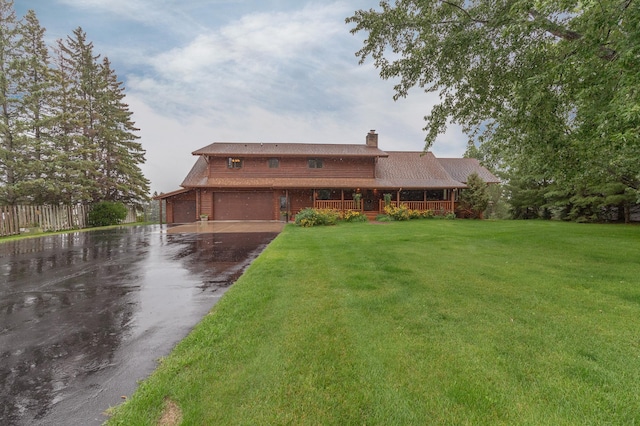 view of front facade with covered porch and a front lawn