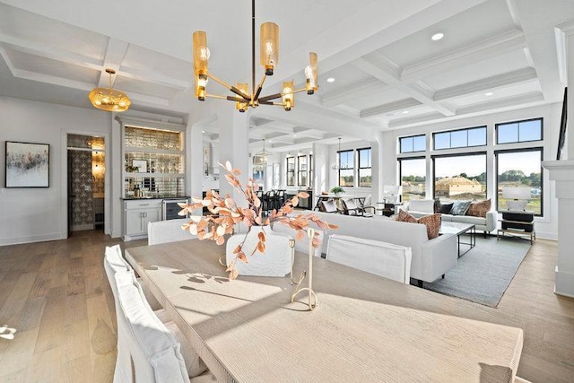 dining area featuring beam ceiling, coffered ceiling, and hardwood / wood-style flooring