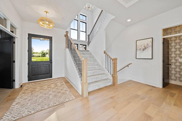 foyer featuring hardwood / wood-style floors and a notable chandelier