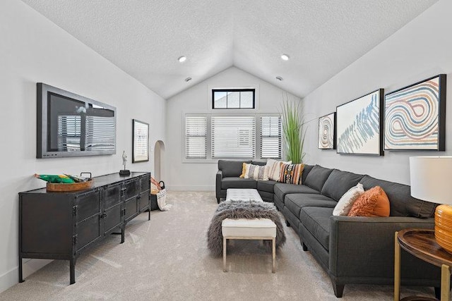 carpeted living room with vaulted ceiling and a textured ceiling