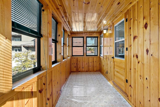 interior space with a wealth of natural light, wooden walls, and wood ceiling