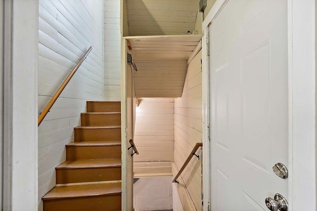 staircase with wooden walls