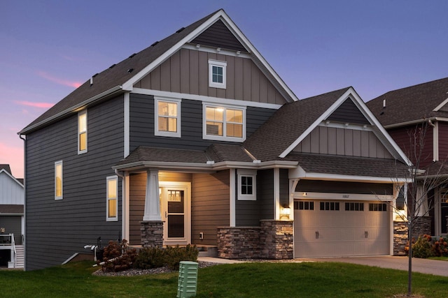 craftsman-style home featuring a lawn and a garage