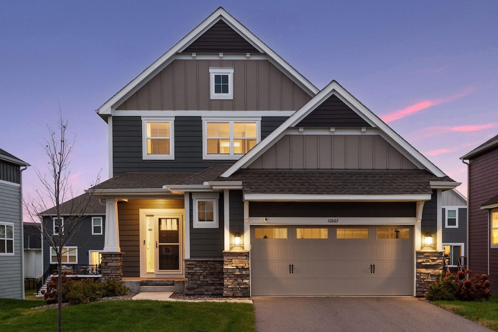 craftsman-style home with a yard and a garage