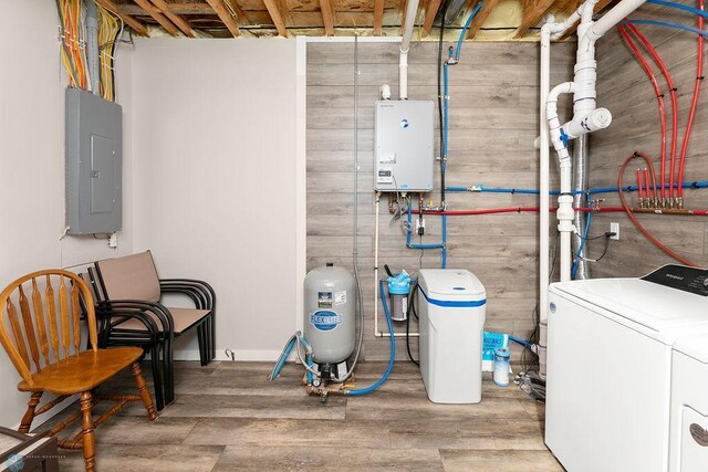 utility room featuring electric panel, water heater, and washing machine and clothes dryer