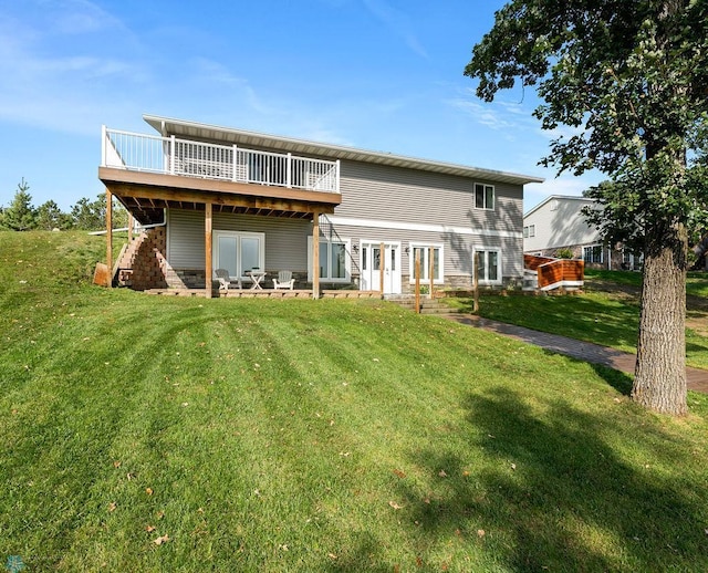 rear view of house featuring french doors, a lawn, and a wooden deck