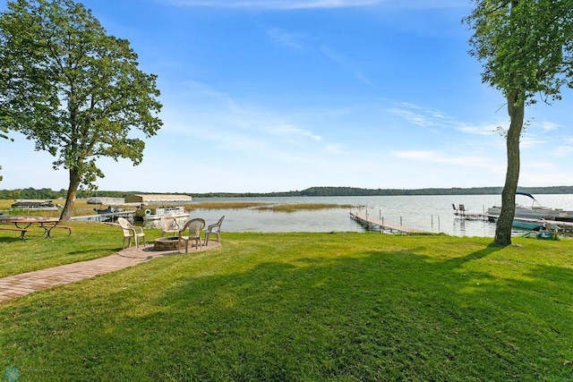 dock area featuring a yard, a fire pit, and a water view