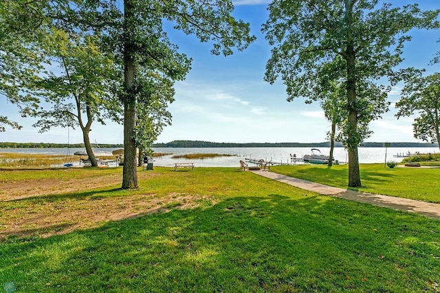 view of yard featuring a boat dock and a water view