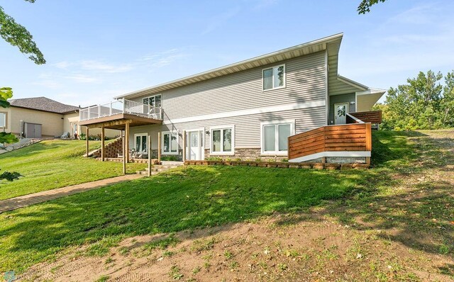 rear view of house with a yard and a deck