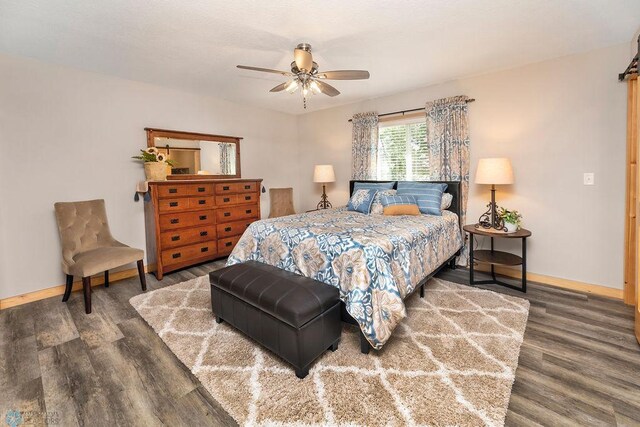 bedroom featuring ceiling fan and dark wood-type flooring