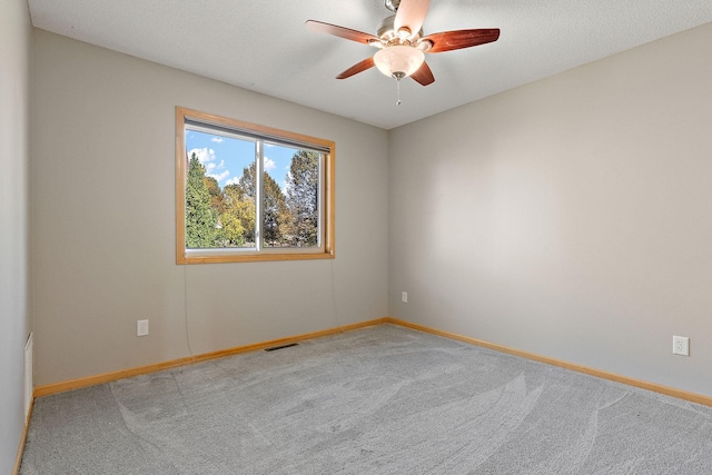 unfurnished room featuring carpet flooring, a textured ceiling, and ceiling fan