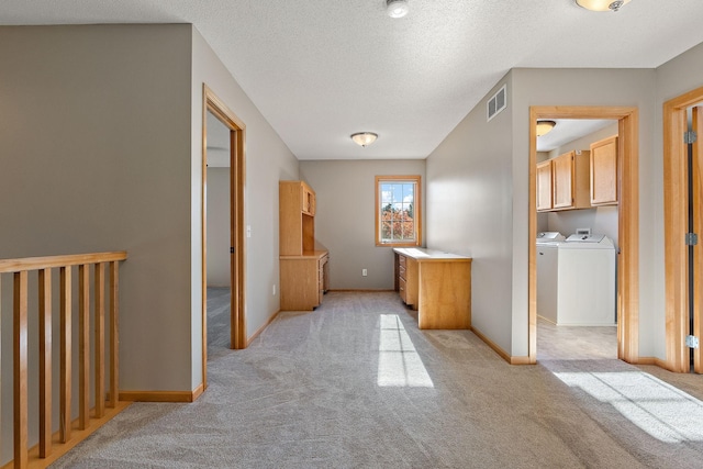 bathroom featuring separate washer and dryer and a textured ceiling